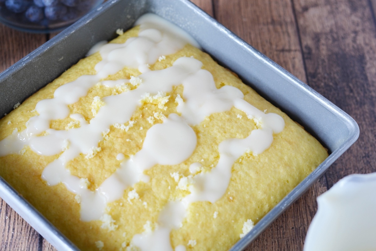 Pudding pouring into the holes of the cake