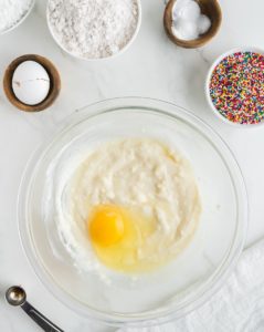 Adding the egg to the sour cream mixture