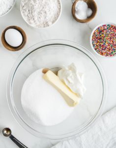 Creaming together the butter, sour cream, sugar, and vanilla in a glass bowl