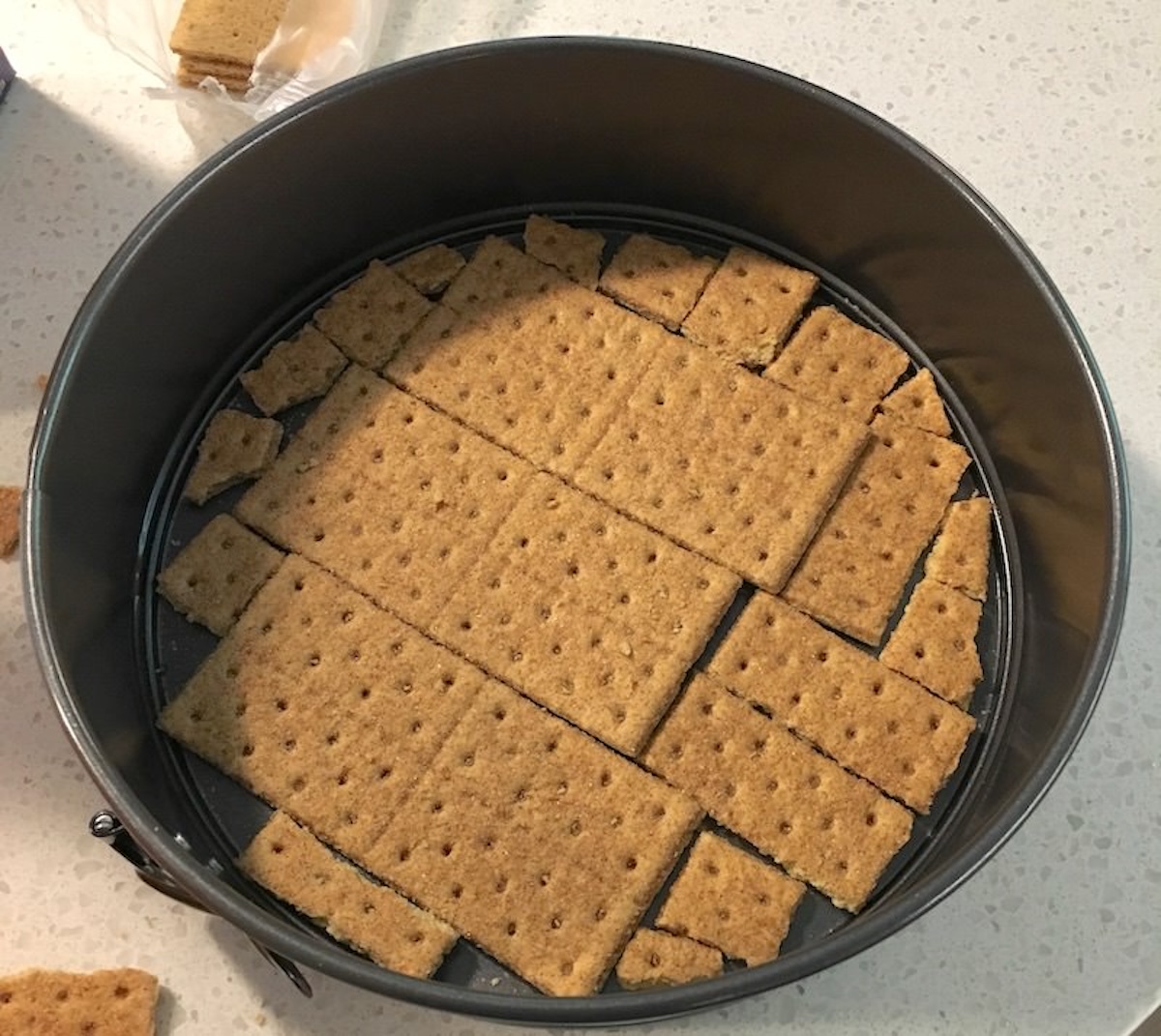 Graham crackers lining the bottom of the pan