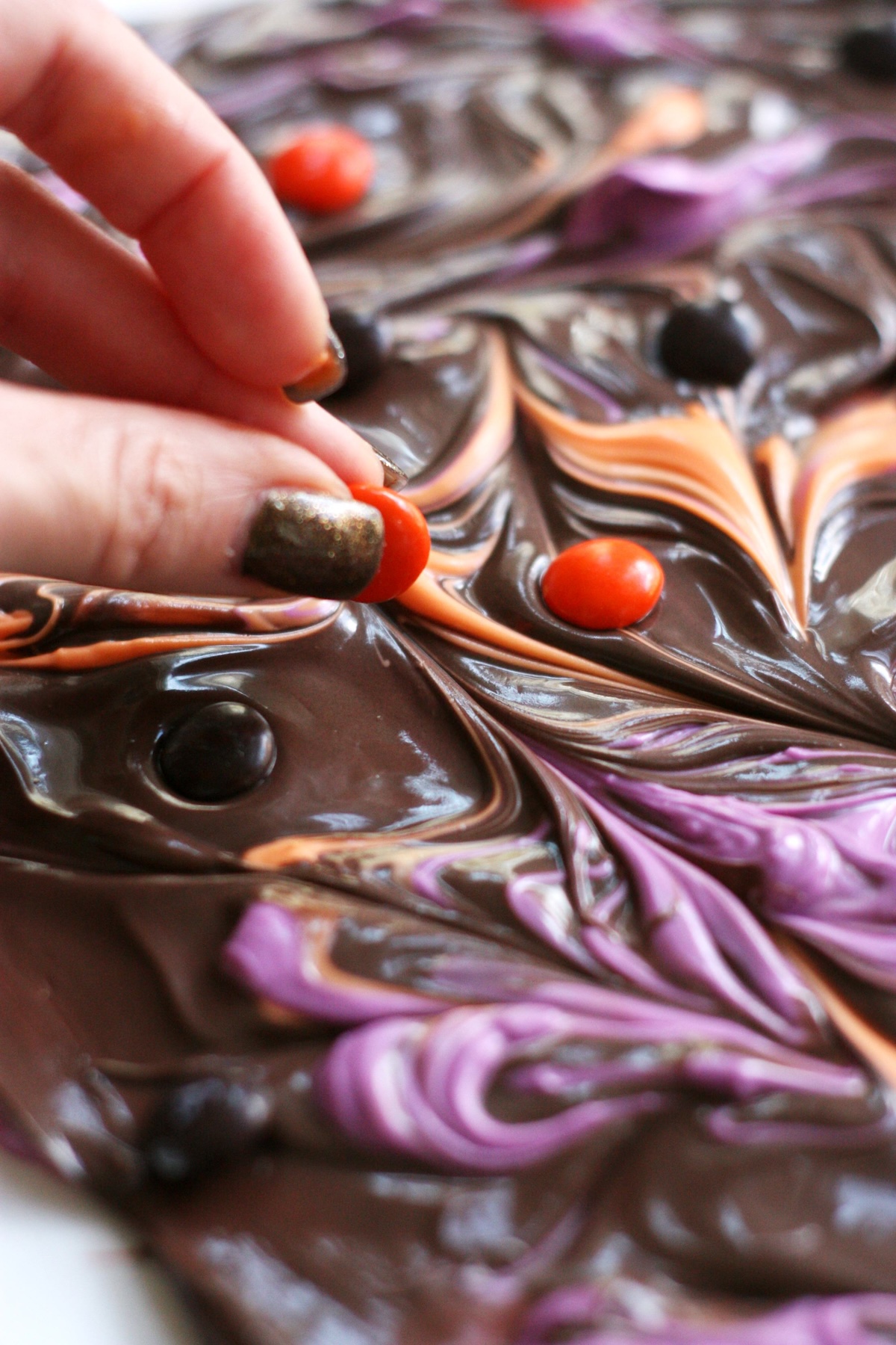 Placing m&ms into the chocolate bark