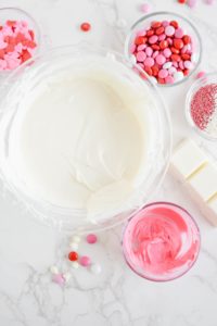 White almond bark melted in one bowl and pink in another