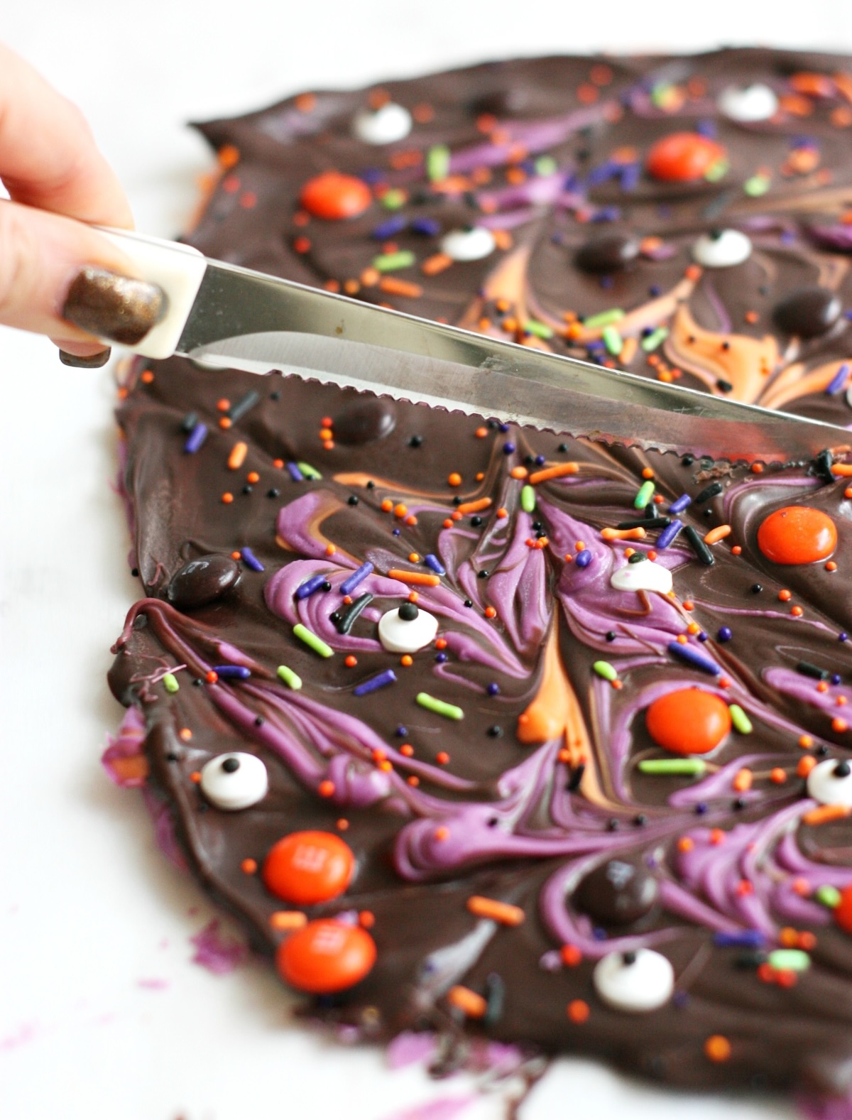 cutting the halloween bark with the knife