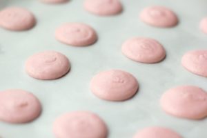 macaron dough piped onto the surface