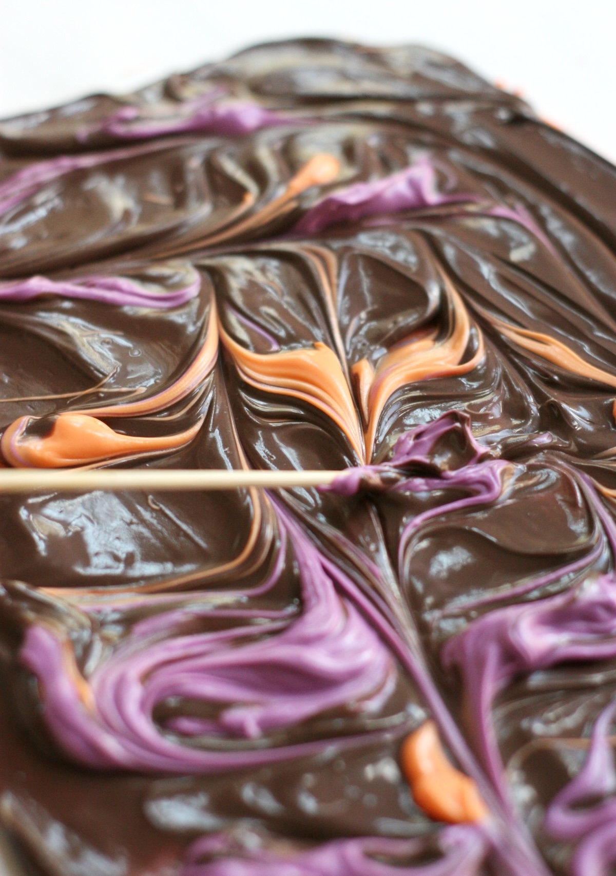 marbling the candy bark with a toothpick