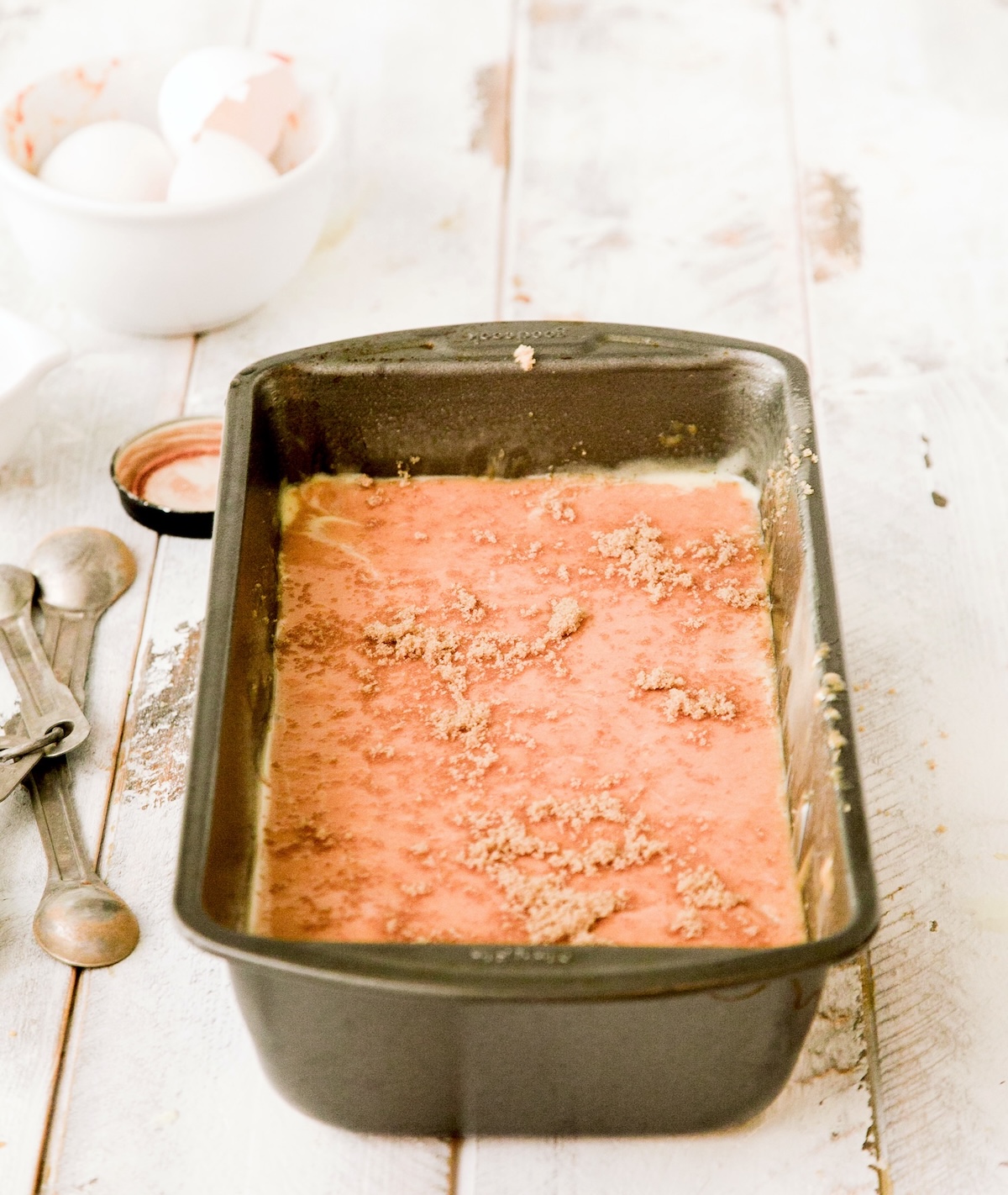 pumpkin bread batter in a pan with sprinkled brown sugar on top