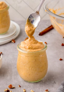 Adding pumpkin pudding to the jars