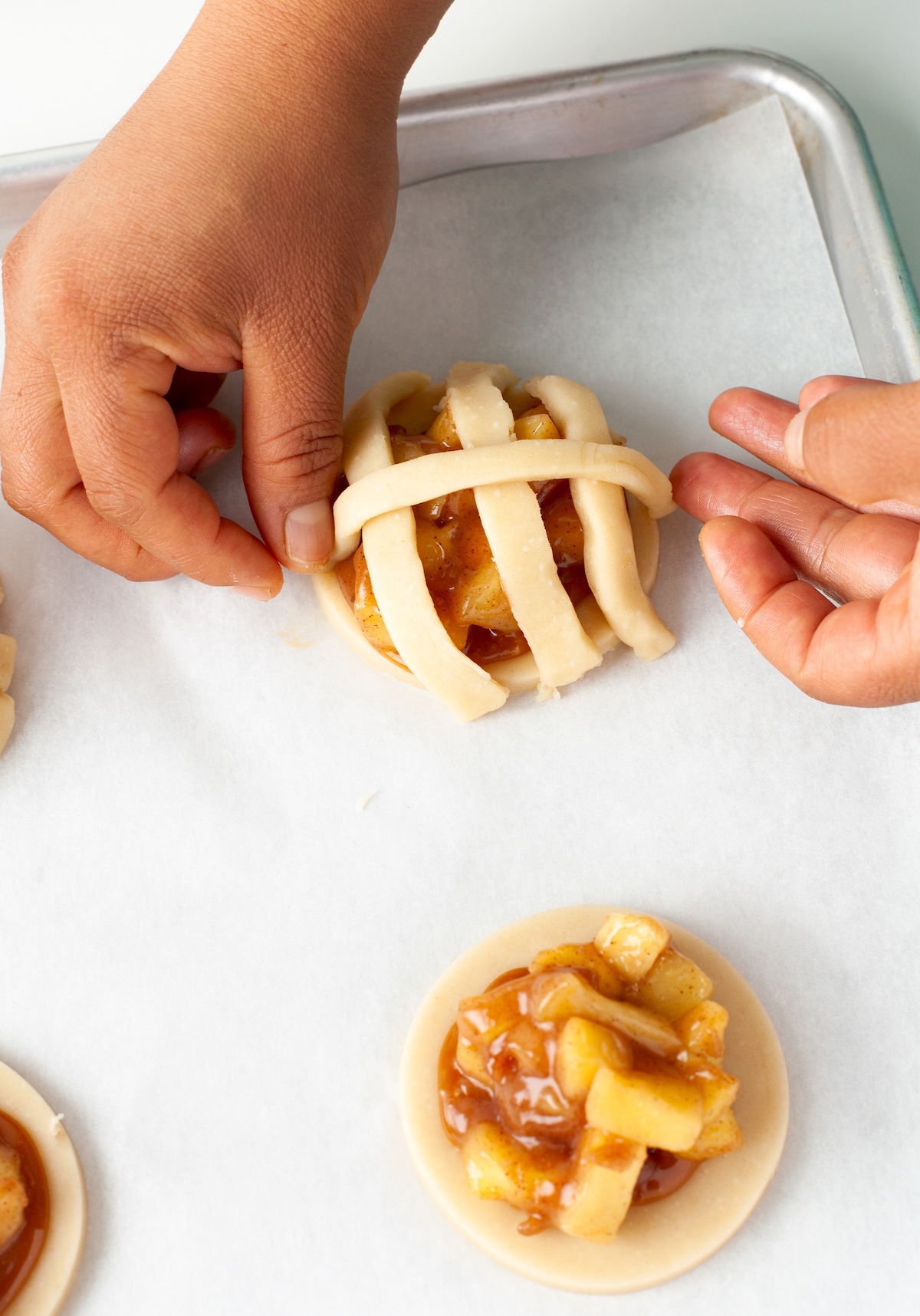 Arranging the dough lattice on top of the cookies