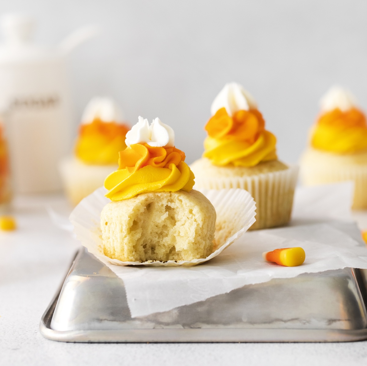 Candy corn cupcake with a bite out of it