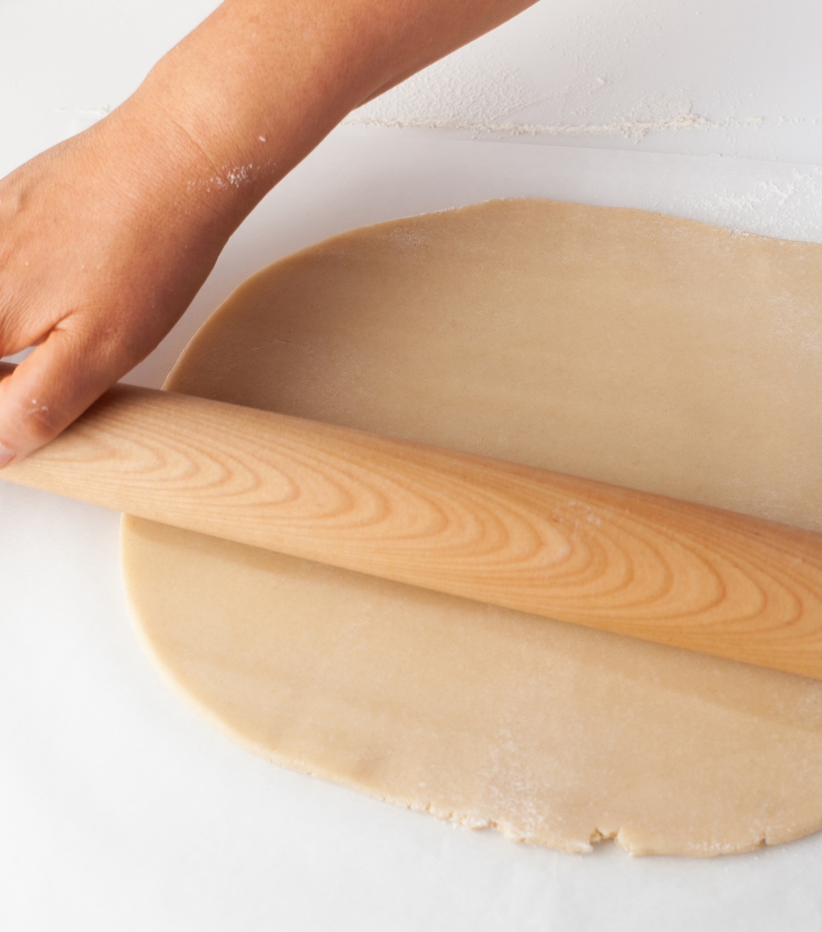 Rolling the mini apple pie cookie dough out with a rolling pin