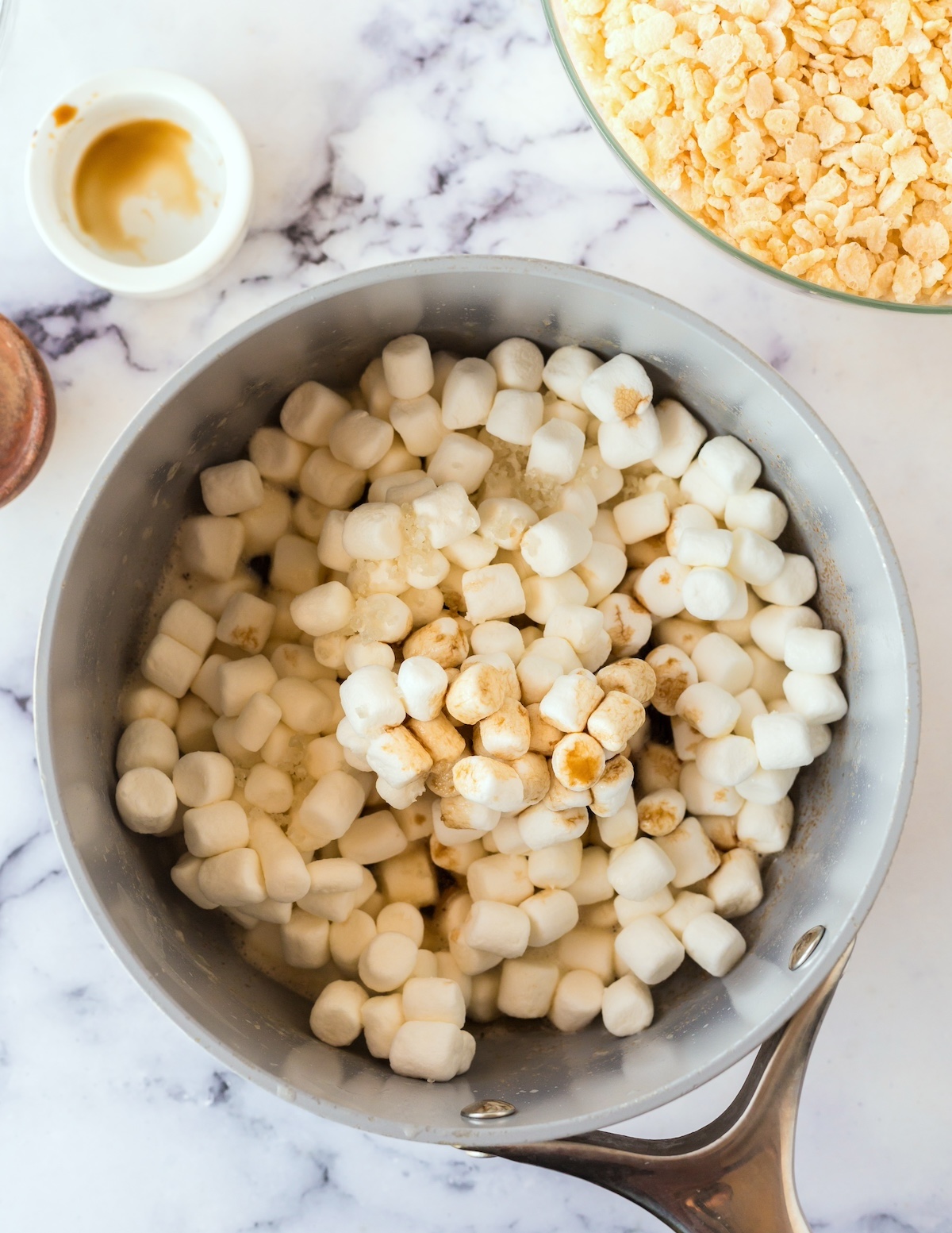 Salt, vanilla, and mini marshmallows added to the pan