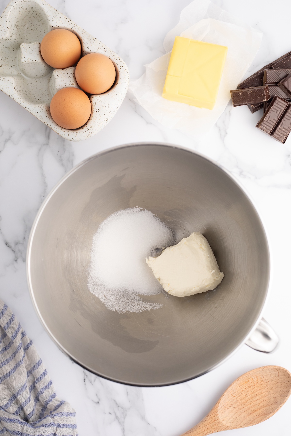 Sugar and cream cheese in a mixing bowl