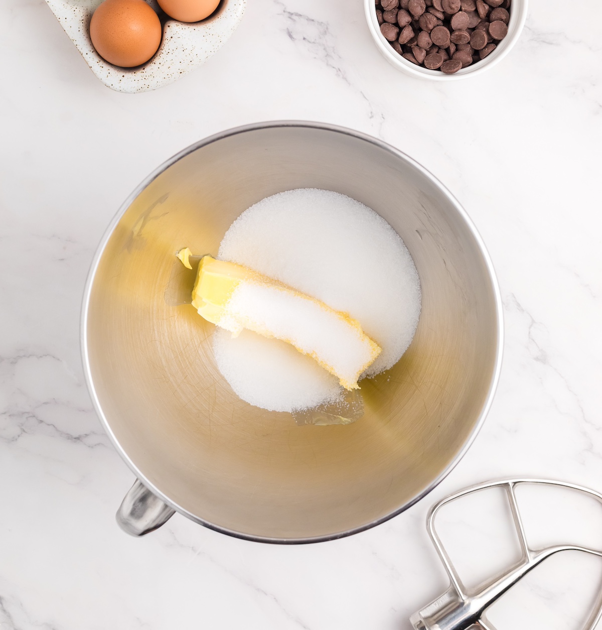 Butter and sugar ready to be creamed in a metal bowl