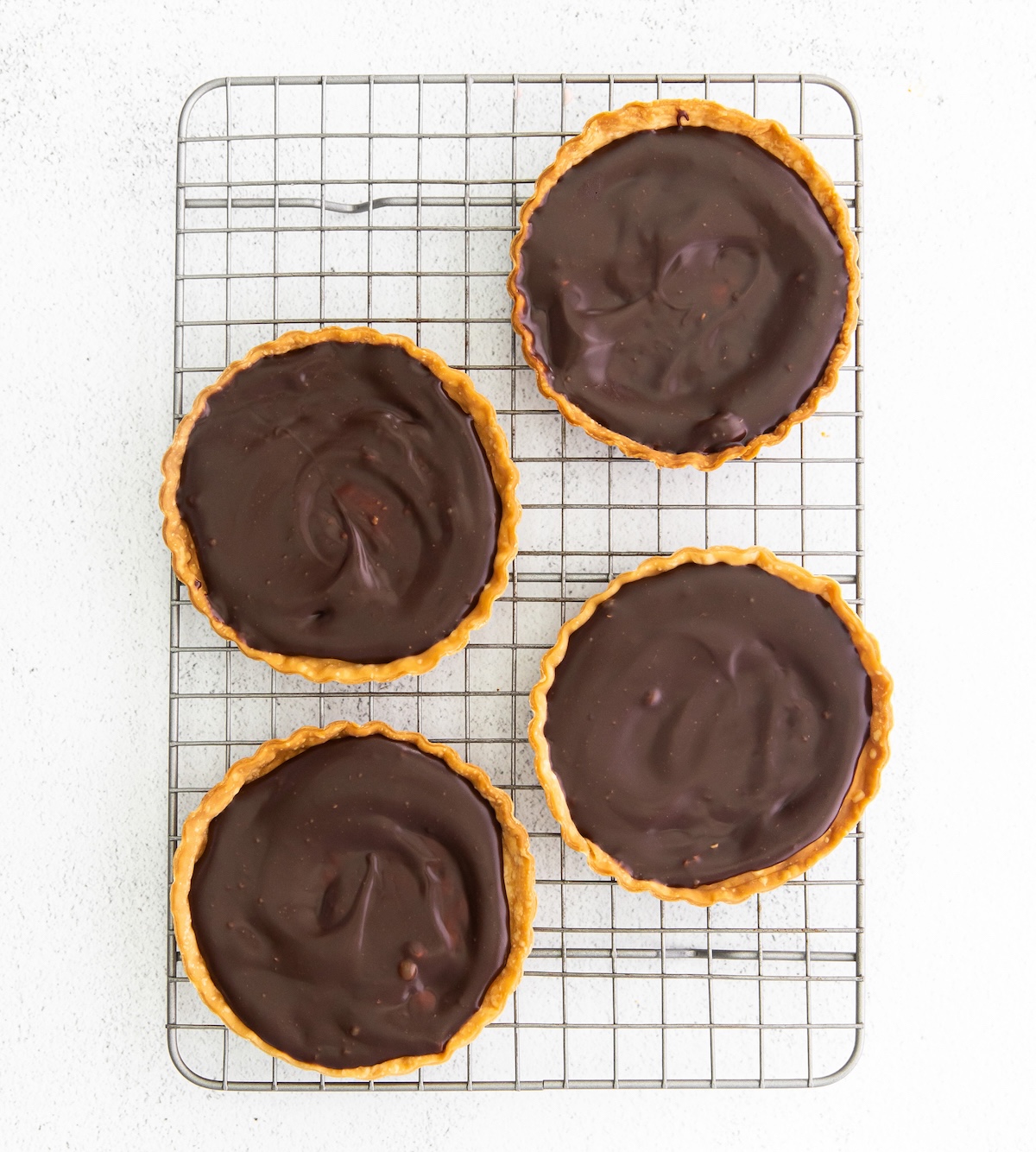 Chocolate ganache spread into the crusts