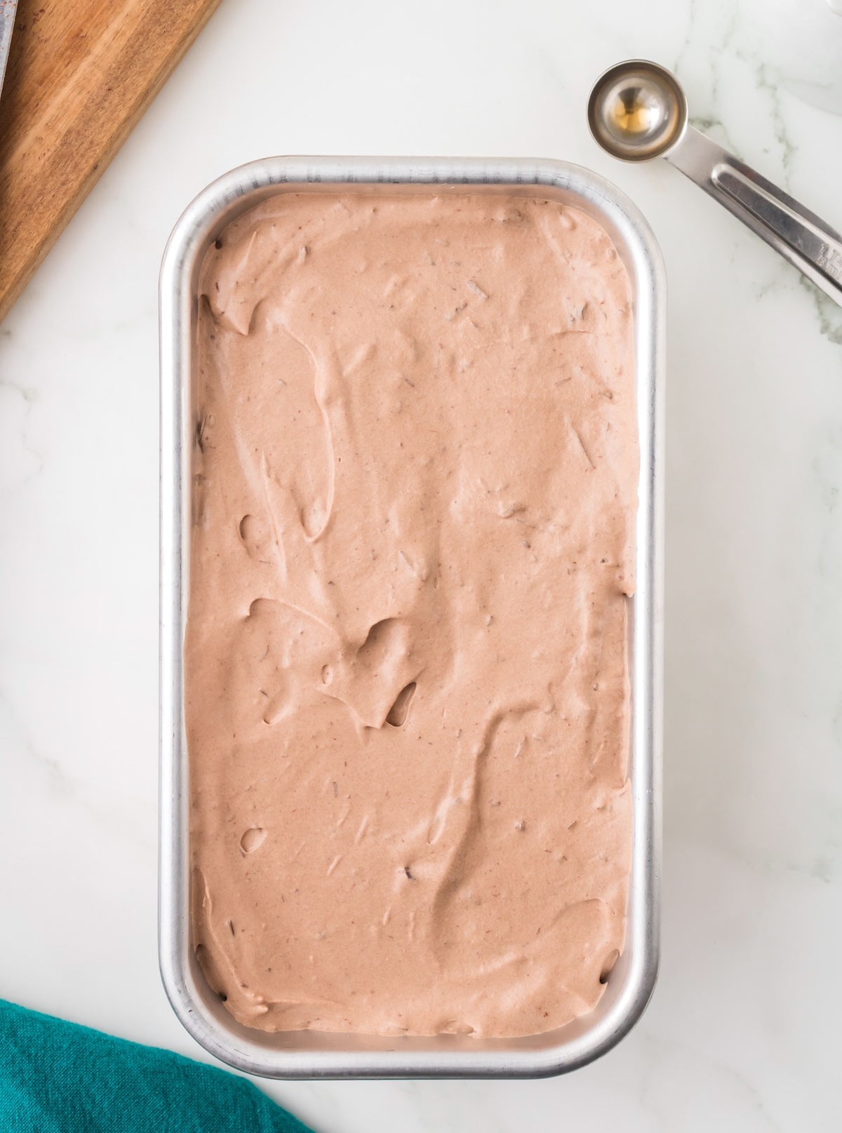 Chocolate ice cream mixture smoothed into a loaf pan