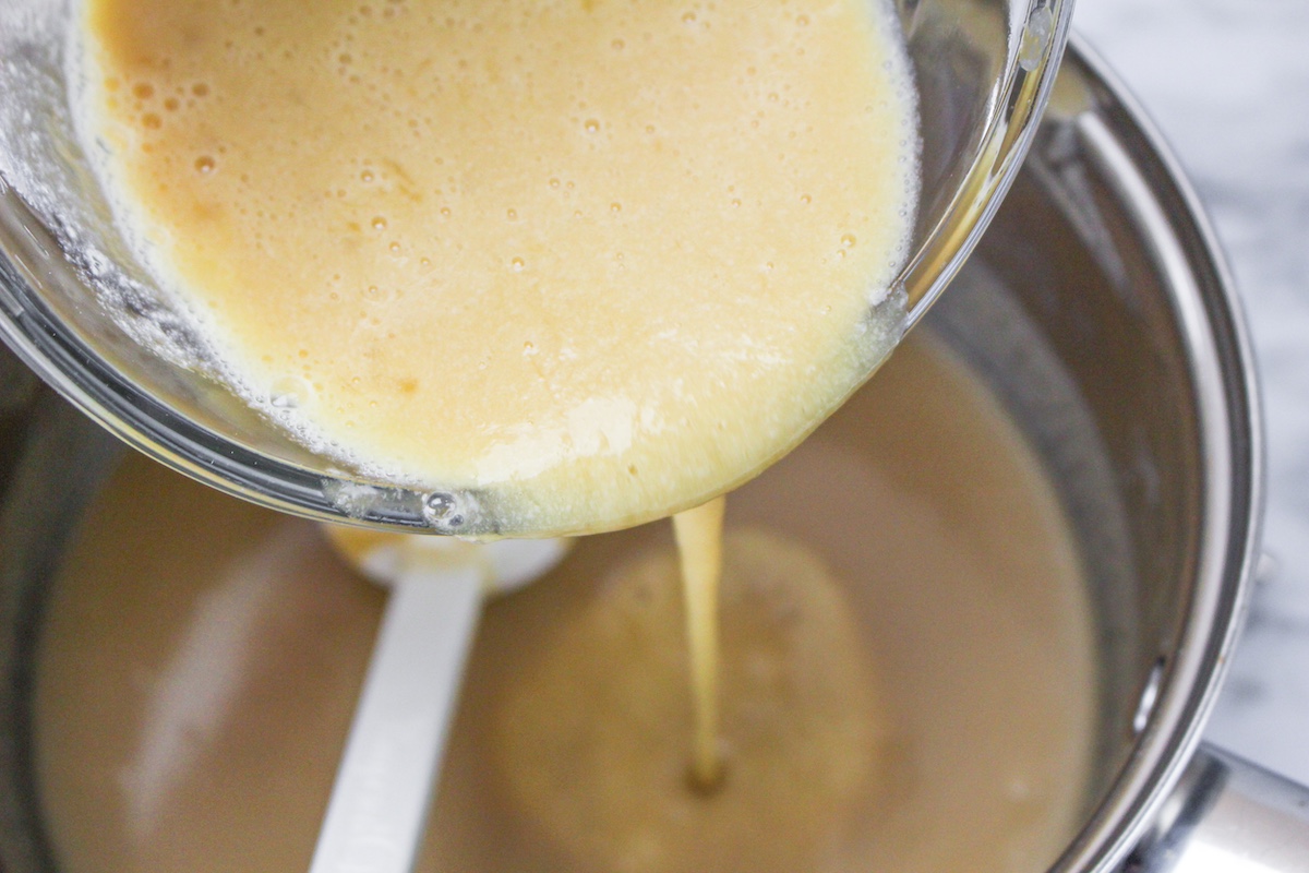 Egg mixture being added back into the ice cream mixture