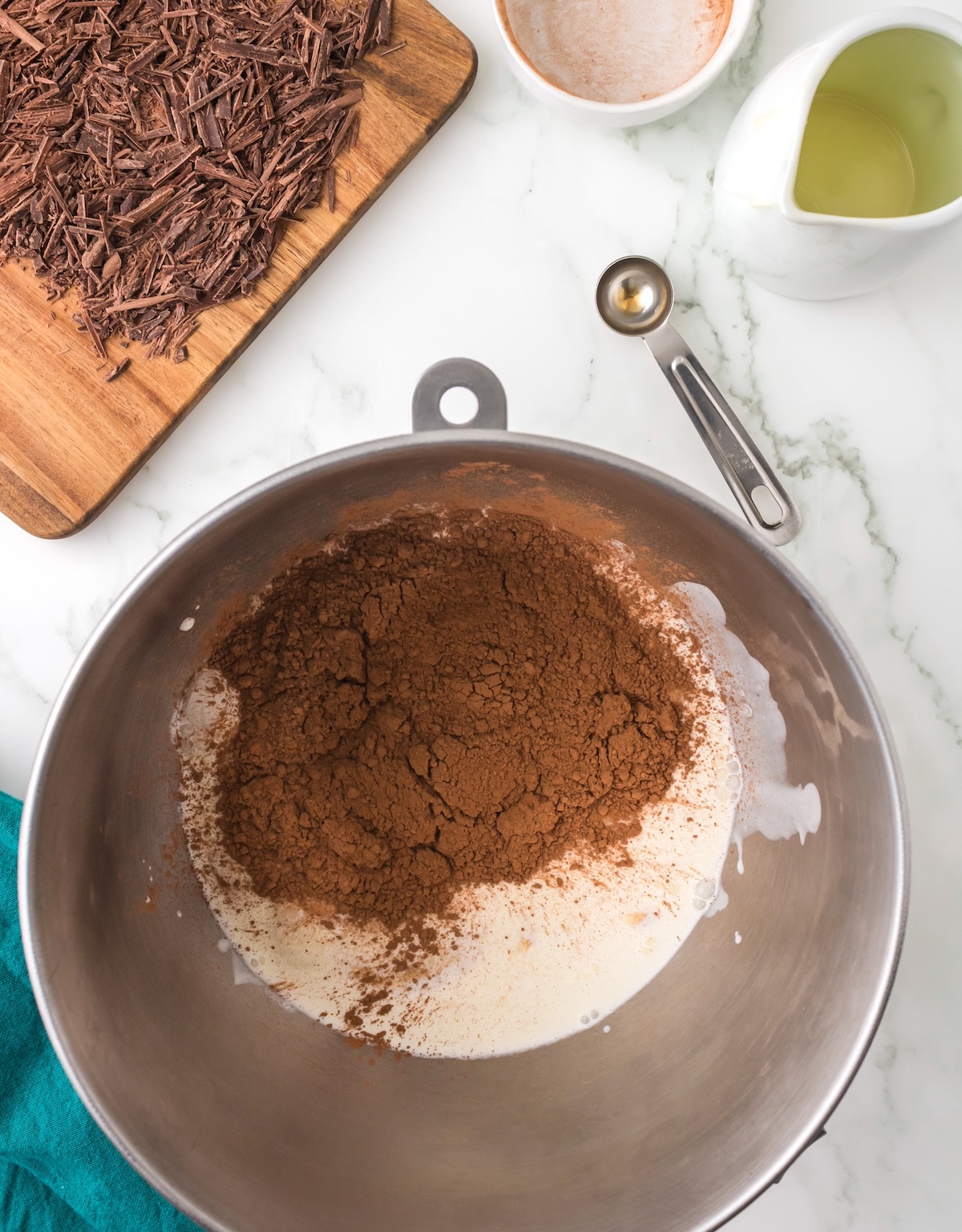 Heavy cream, sweetened condensed milk, vanilla, and cocoa powder in a bowl