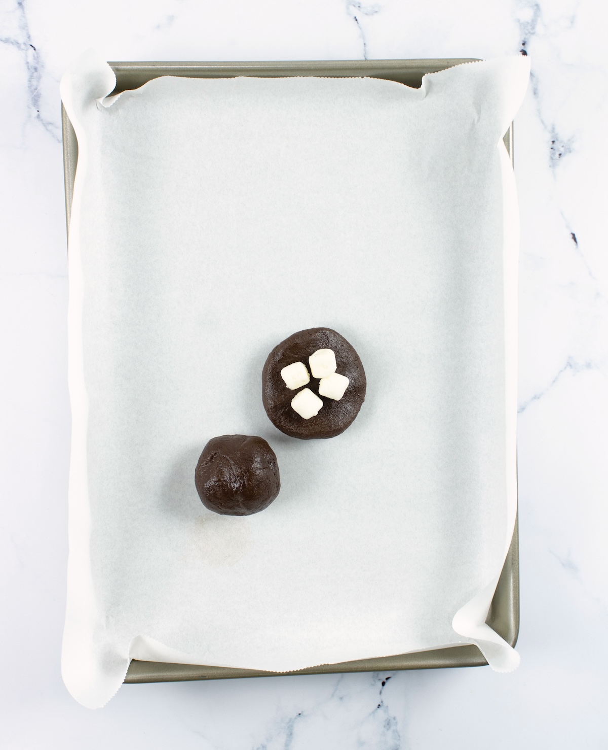 Mini marshmallows on top of a ball of chocolate cookie dough