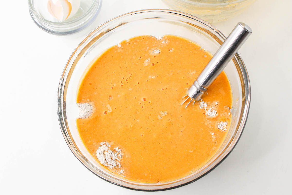 Mixing the dry ingredients into the wet ingredients for pumpkin pancakes