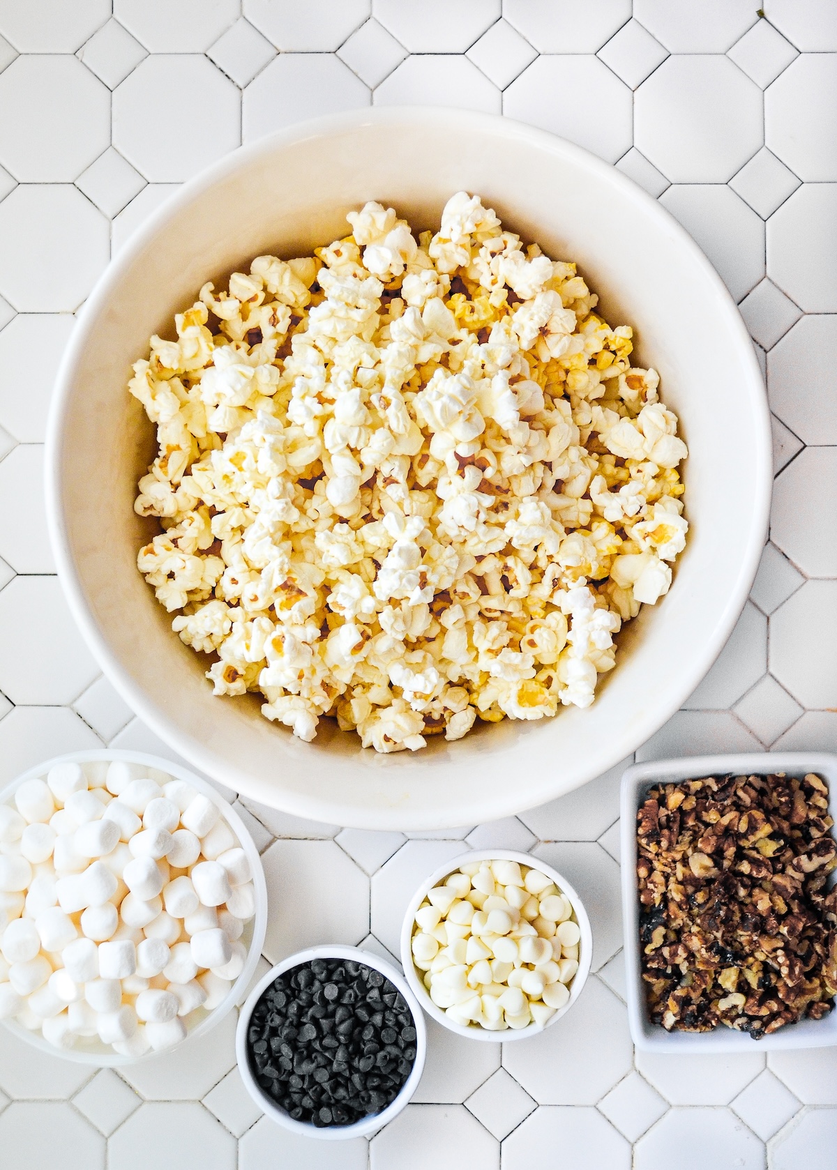Popped popcorn, white chocolate chips, chocolate chips, walnuts, and marshmallows