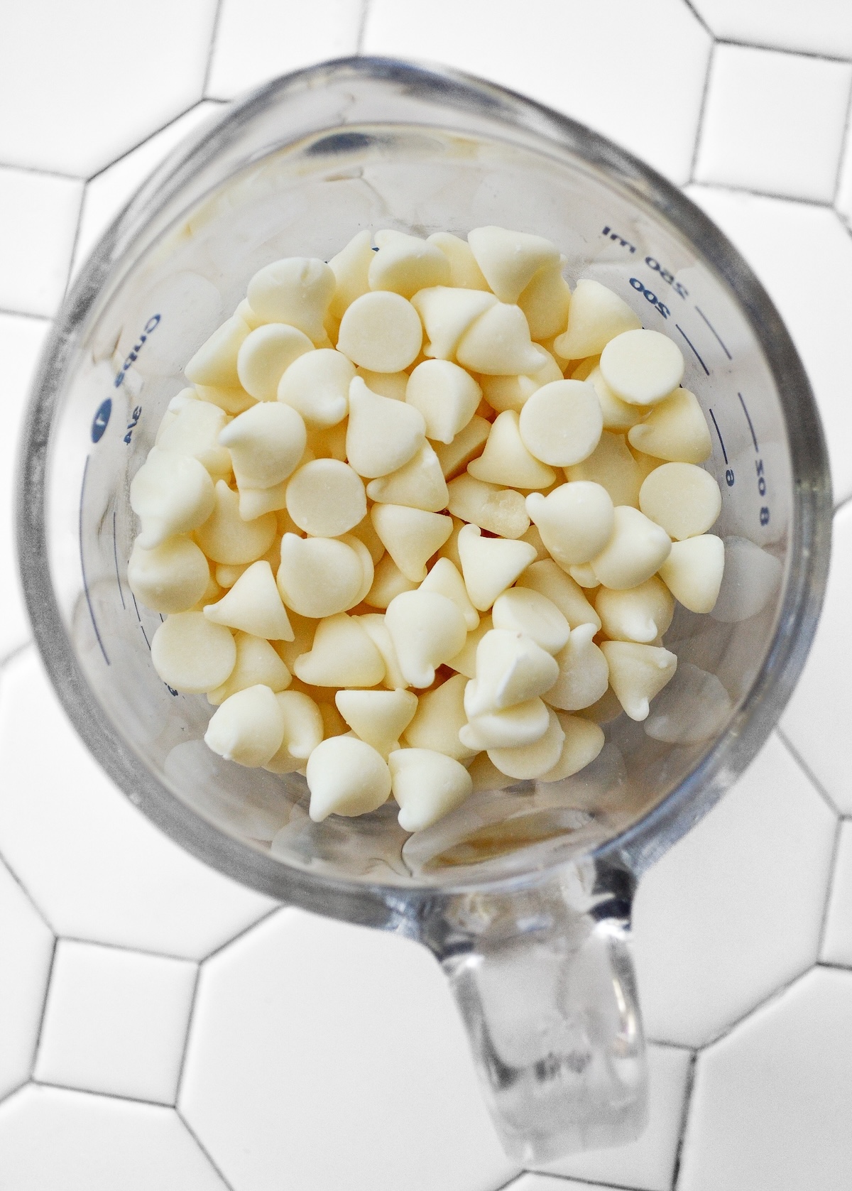 White chocolate chips in a measuring glass