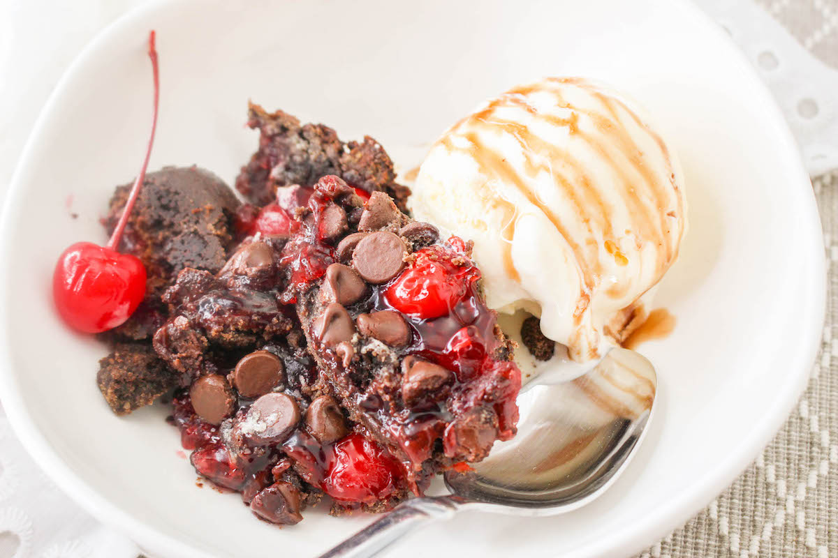 cherry chocolate cake with pie filling in a bowl with ice cream