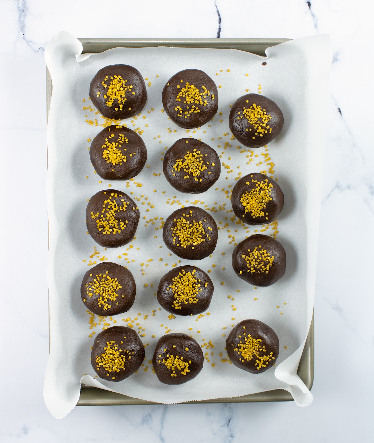 chocolate marshmallow cookie dough balls on a baking sheet