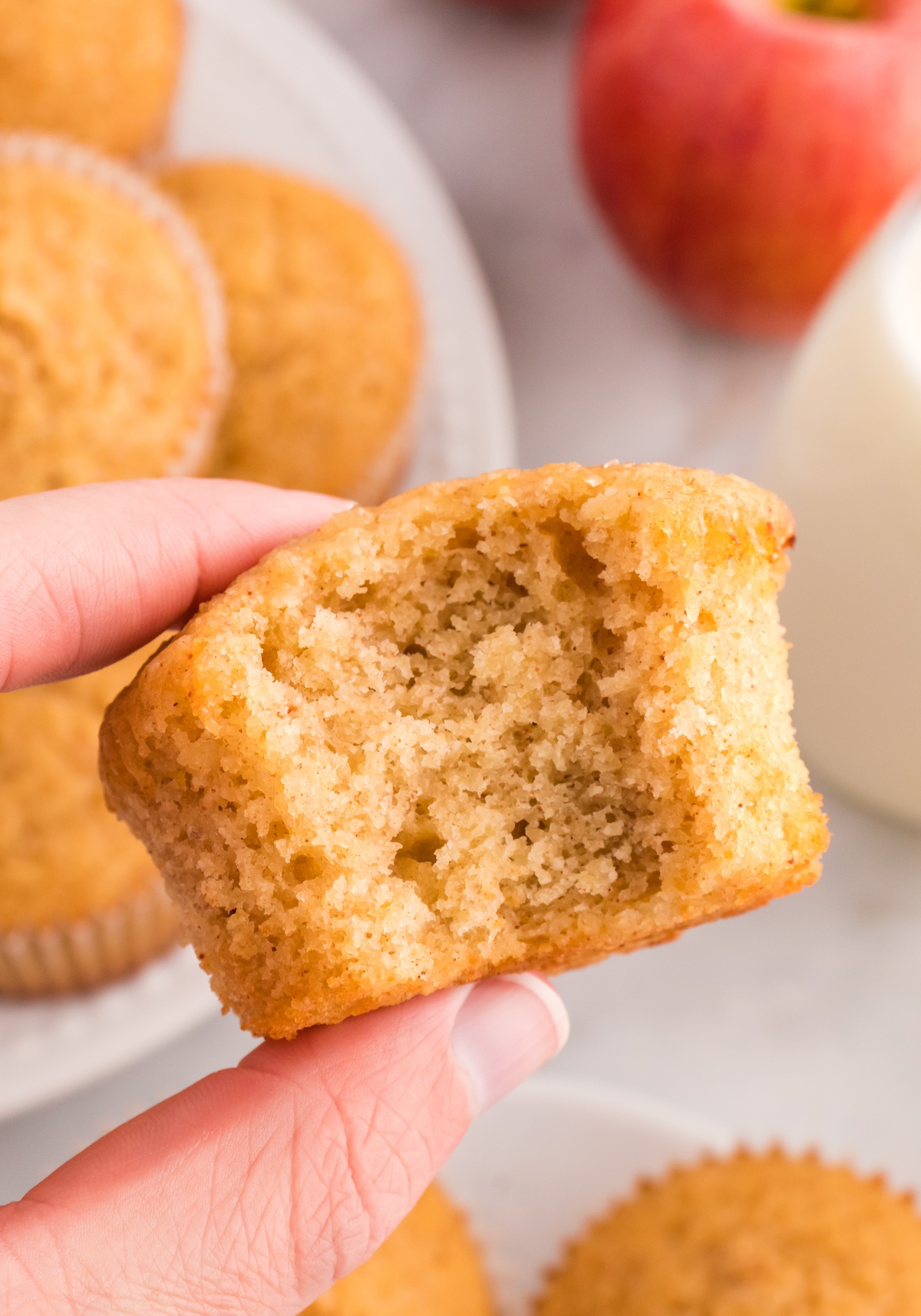 hand holding an apple cider muffin