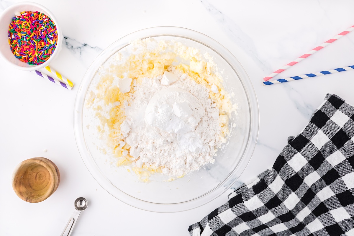 mixing the dry ingredients into the funfetti cookie batter