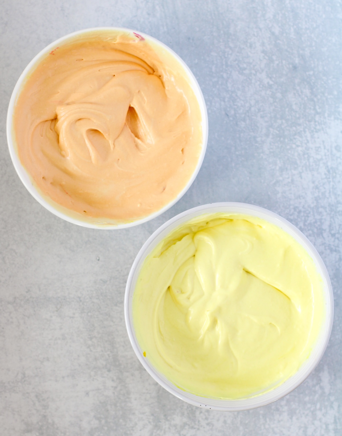 orange and yellow dyed ice cream in bowls