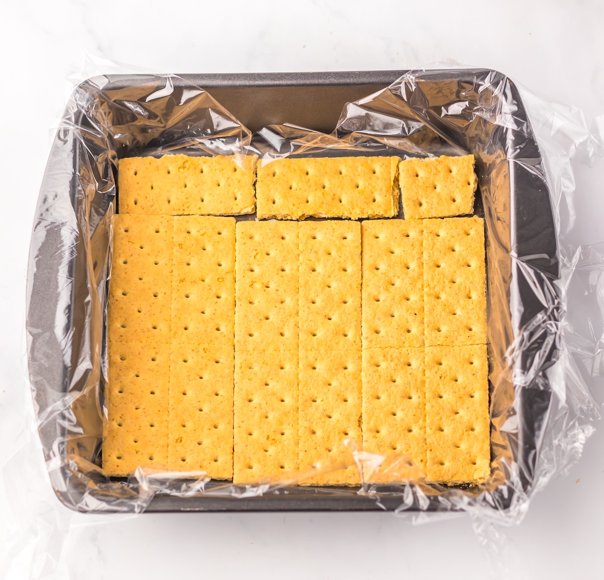 pan lined with graham crackers across the bottom