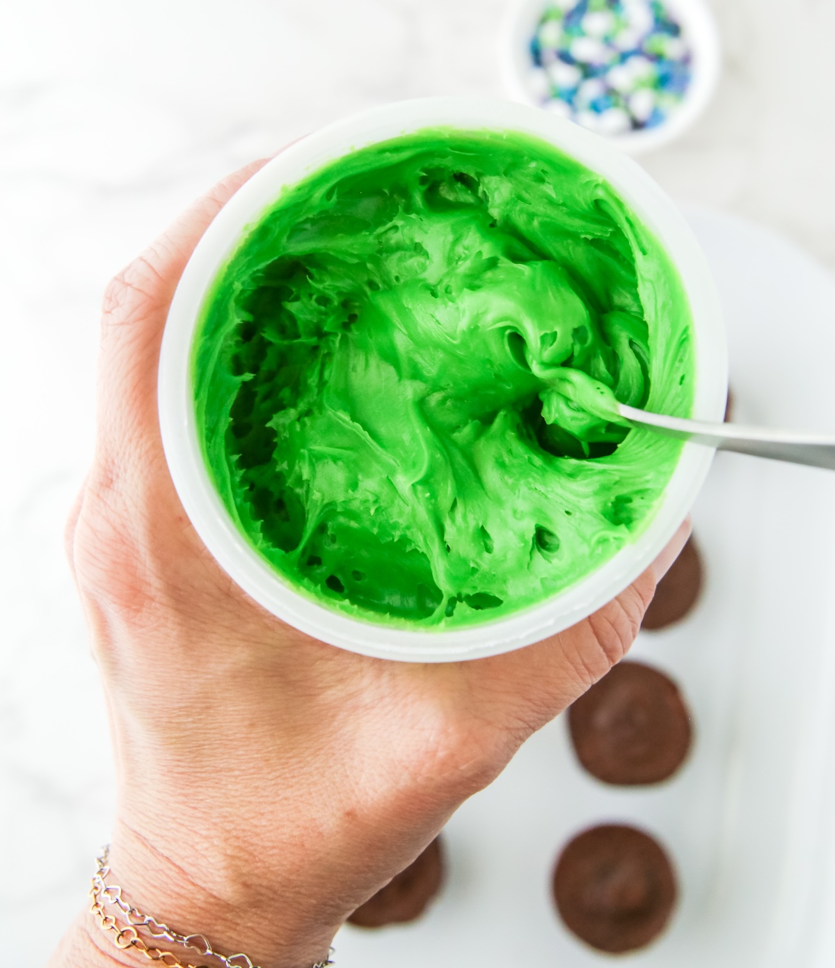 Stirring the green frosting