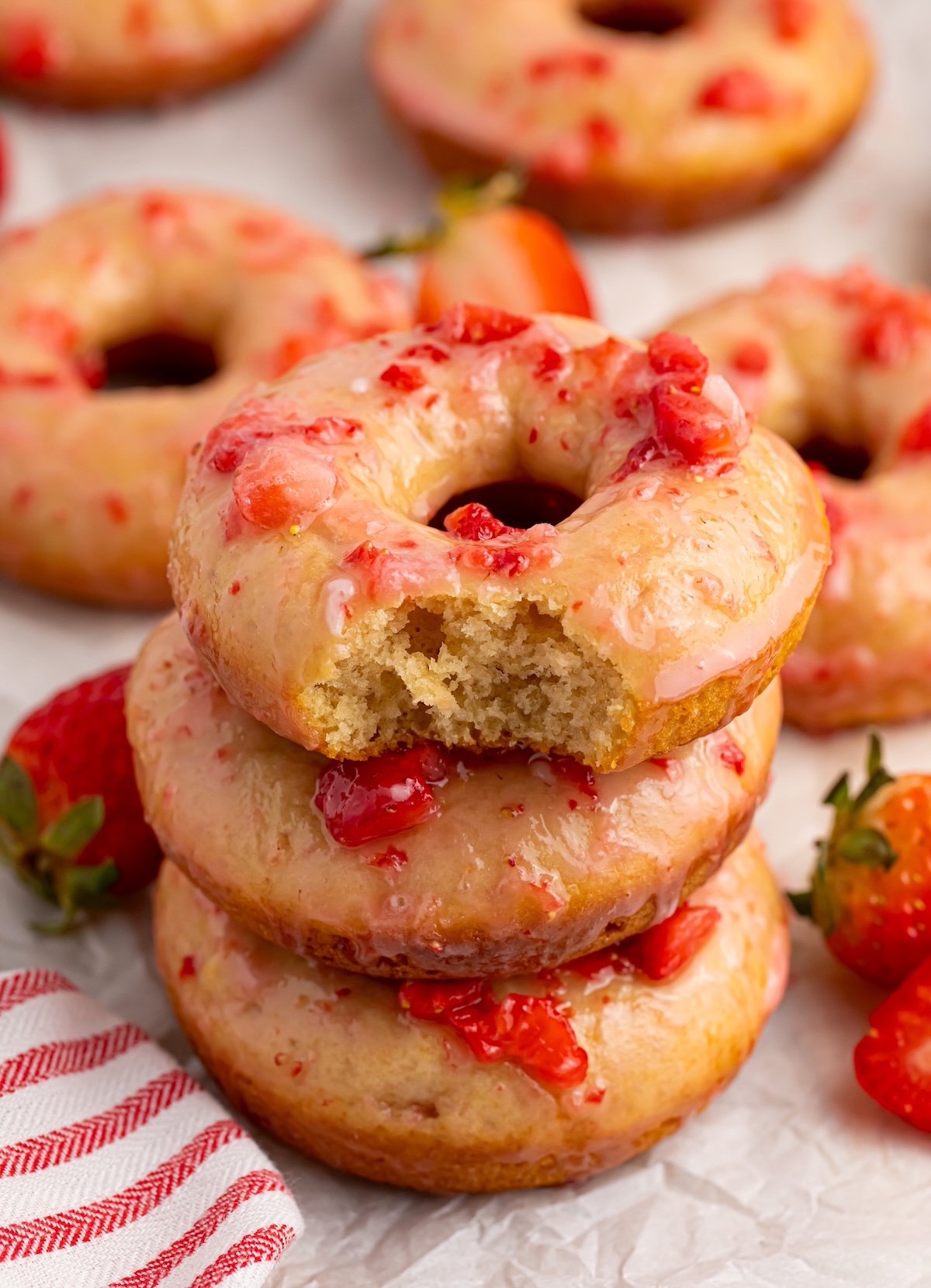 strawberry donut with a bite taken out of it