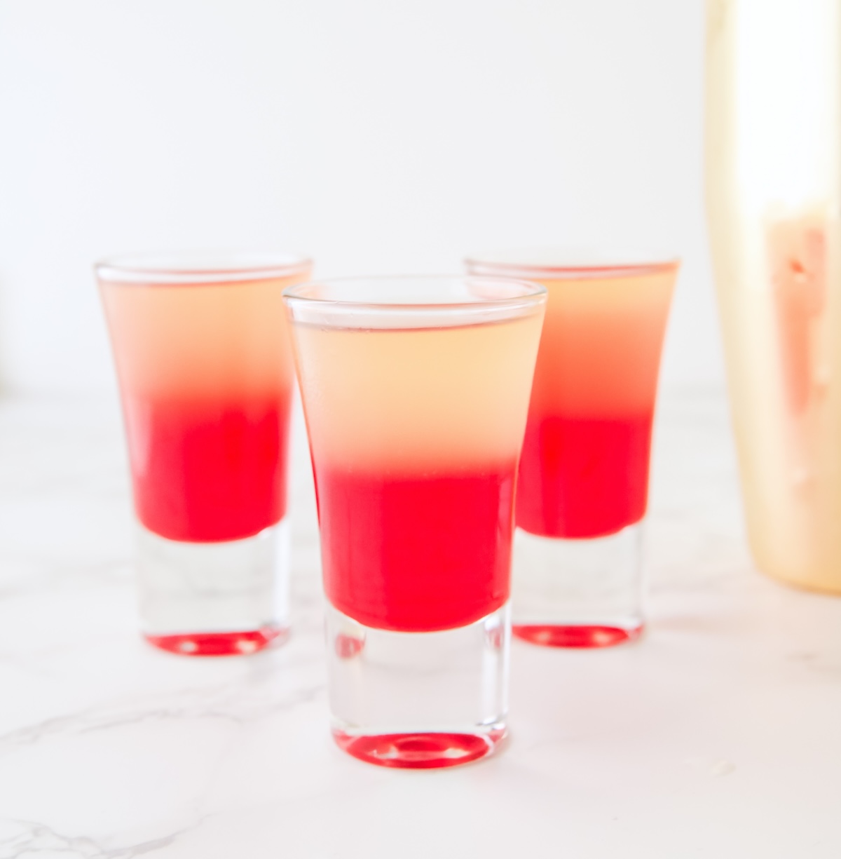 shot glass filled with grenadine and pineapple juice mixture