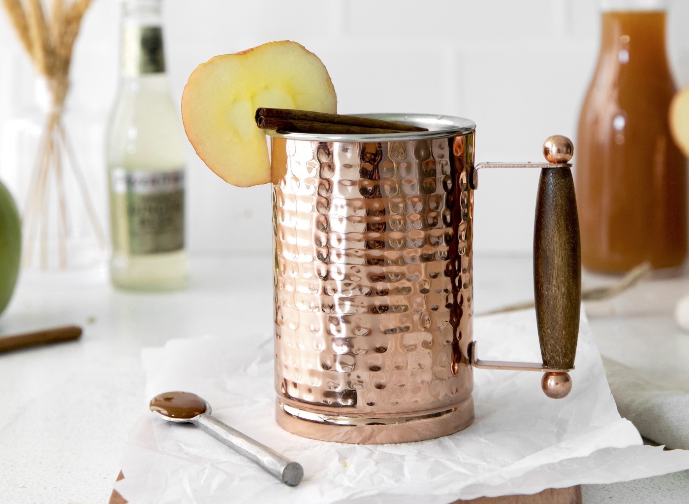 Apple slice and cinnamon stick added to the mule