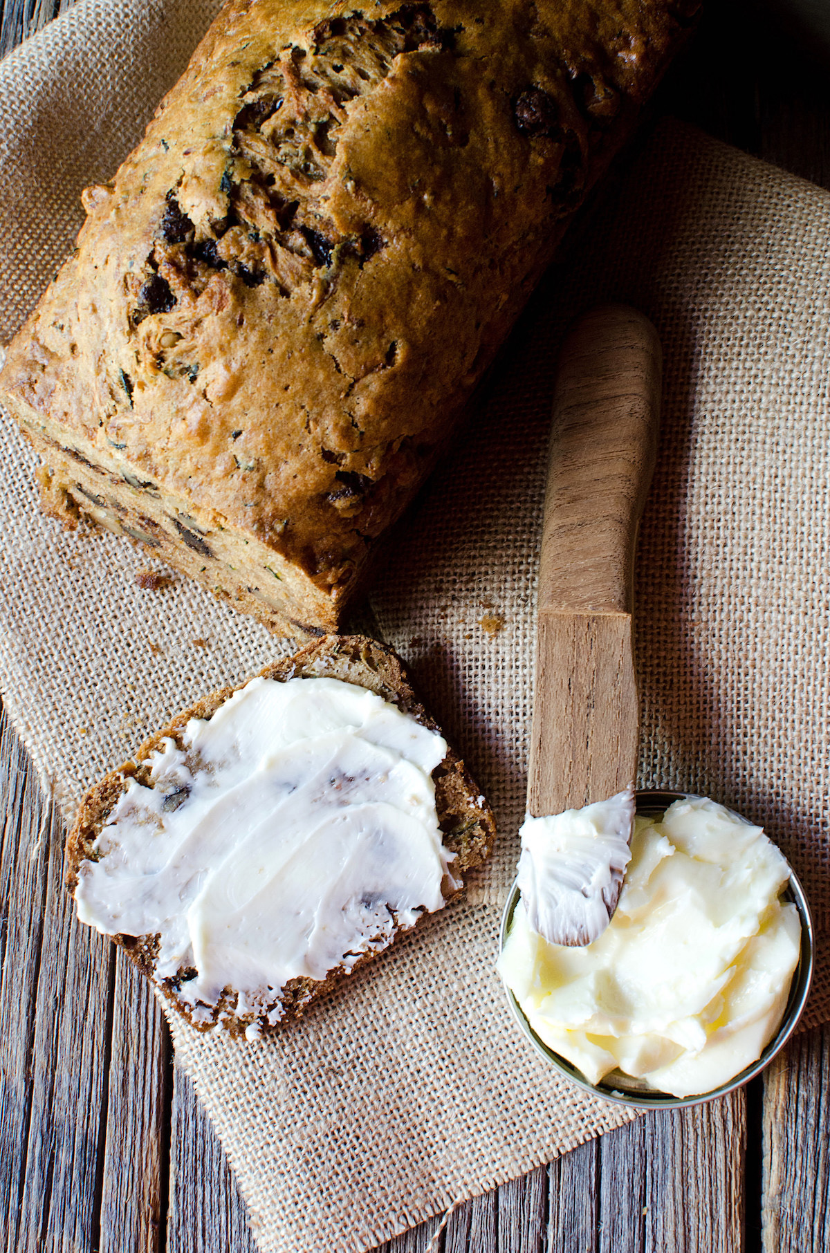 Loaf of chocolate chip zucchini bread with a piece cut off